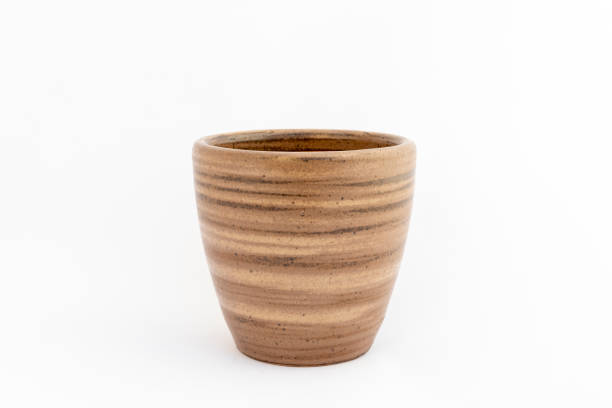 istock Beautiful earthen tone ceramic pot with striped texture isolated on white background with copy space 2190489260