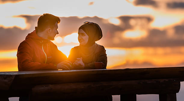istock Lovely romantic couple enjoying the sunset. 2190490343