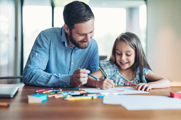 istock Little girl enjoying drawing time with her dad 2190490409