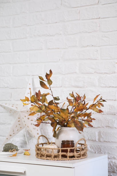 istock Creating Beautiful Autumn Decor Using Dried Leaves Arranged in a Rustic Style Vase 2190491175