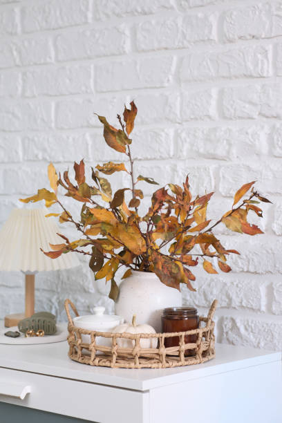 istock Creating Beautiful Autumn Decor Using Dried Leaves Arranged in a Rustic Style Vase 2190491374