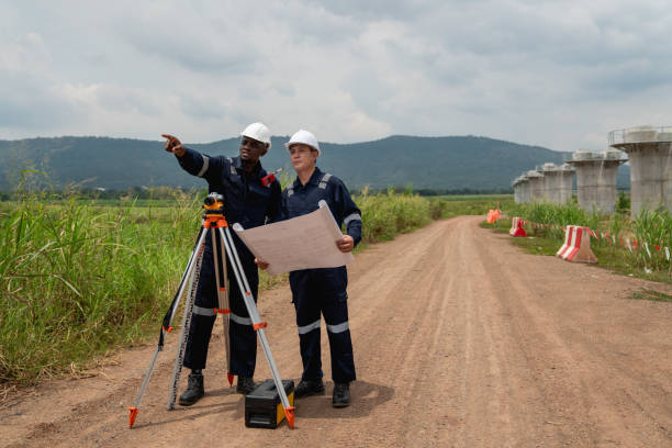 istock The survey team is using a theodolite and road construction plans to take measurements. Civil engineers are working with surveying tools to collect data for the construction project. 2190491721