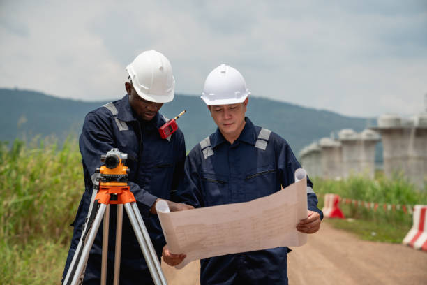 istock The survey team is using a theodolite and road construction plans to take measurements. Civil engineers are working with surveying tools to collect data for the construction project. 2190492191