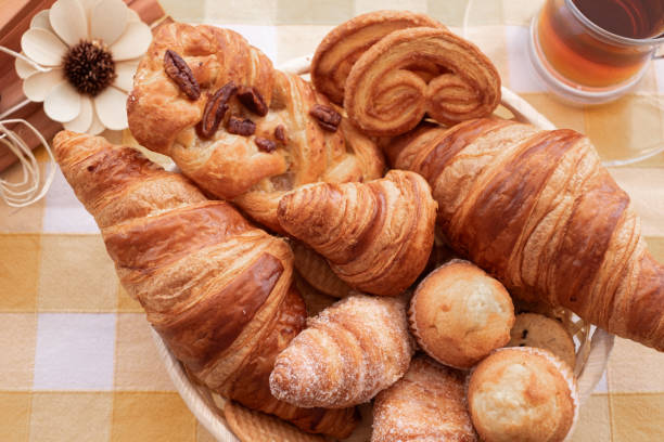 istock Close-up on bakery - various kinds of breadstuff. Rye bread, wholemeal, baguette, sweet bakery products and croissant 2190494541