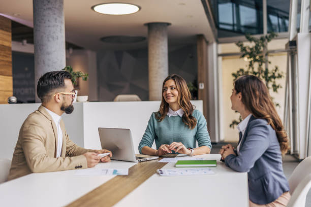 istock A group of businesspeople working on a solution in a modern office. 2190495070