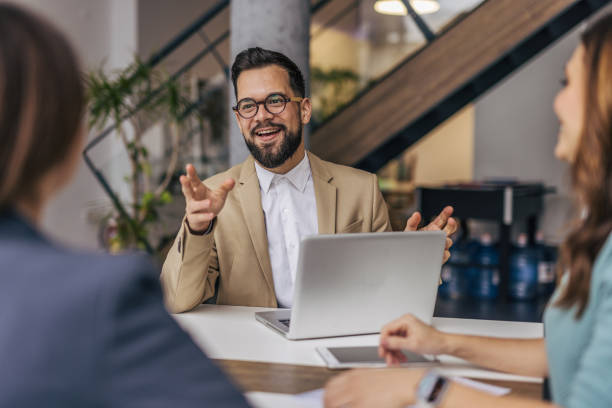 istock A group of businesspeople working on a solution in a modern office. 2190495486