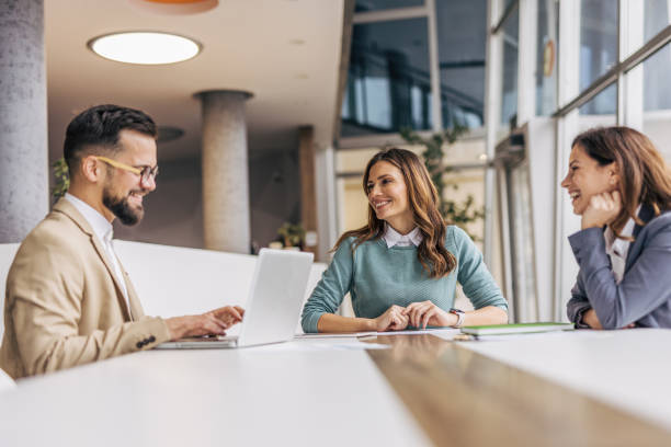 istock A group of businesspeople working on a solution in a modern office. 2190495494