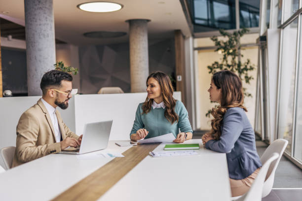 istock A group of businesspeople working on a solution in a modern office. 2190495558