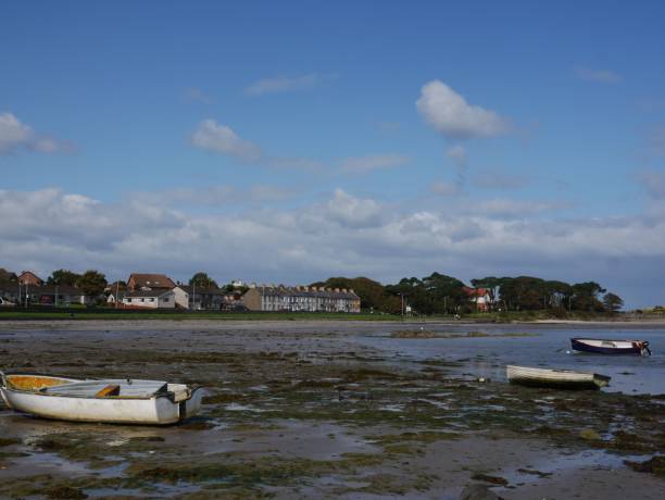 istock Boats on a calm shoreline 2190496008