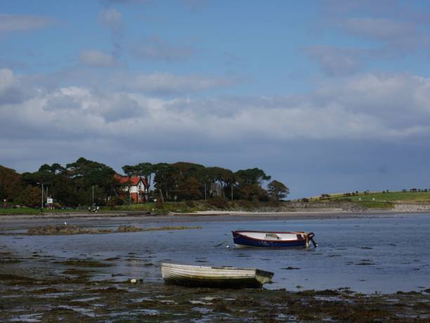 istock Boats on a calm shoreline 2190496026