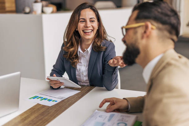 istock Two business people talk project strategy at office 2190497675