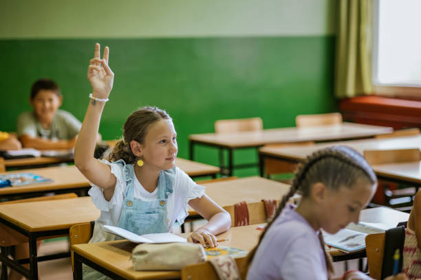 istock Students raising hands to participate in a classroom discussion during an afternoon lesson at a local school 2190497837