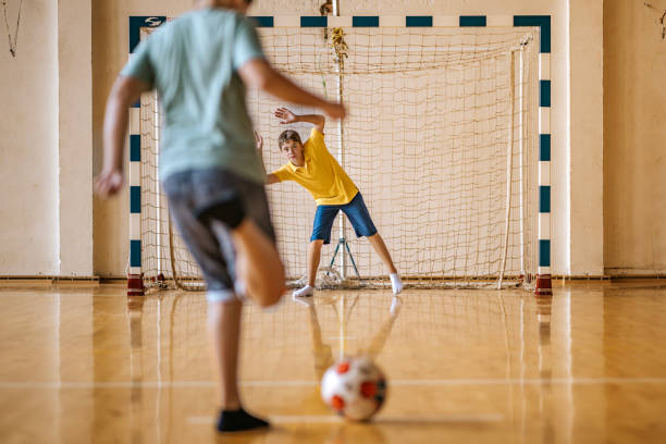 istock Students engage in a soccer practice session inside the school gymnasium during physical education class 2190497949