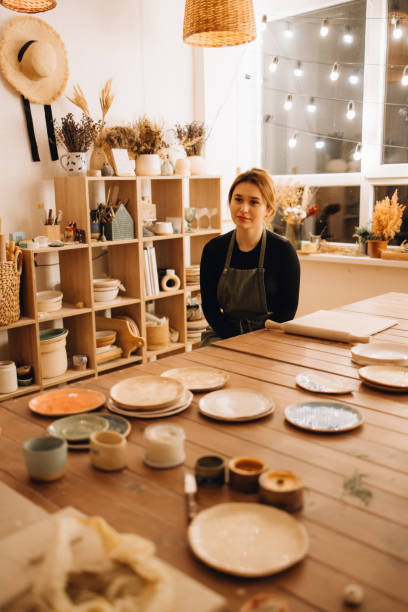 istock Excited beautiful young woman sitting in the pottery studio 2190501196