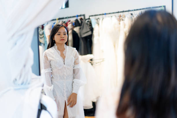 istock Bride Admiring Herself in Lace Bridal Robe Reflection During Fitting 2190502443