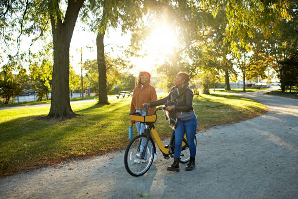 istock Eco-minded friends walking and talking at sunny public park 2190502704