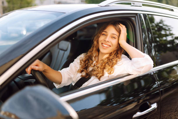 istock Young woman driving vehicle confidently, seatbelt. 2190503094