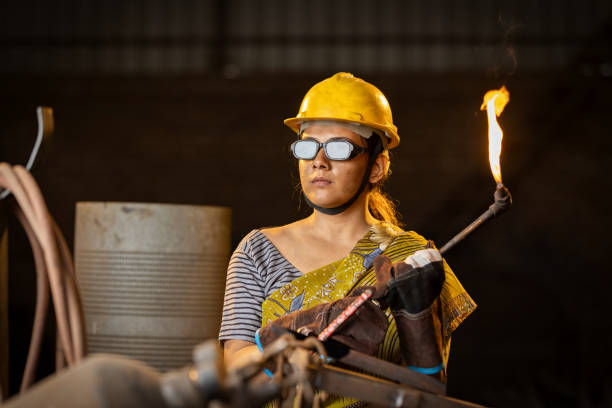 istock Female industrial worker working with blow torch in factory 2190503628
