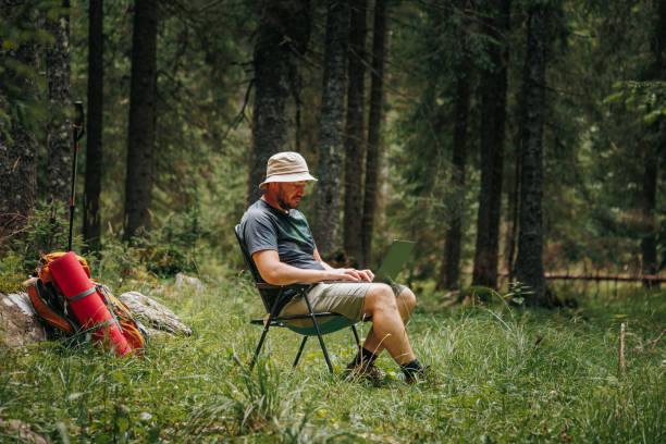 istock Tech Trek Adventurous Remote Work Session with a Laptop Hiking Fusion 2190505462