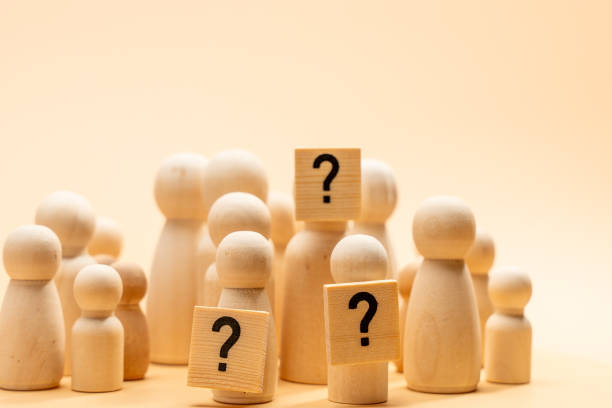 istock A group of wooden people holding a question mark. 2190507222