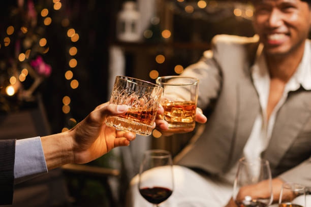istock Happy two man clinking glasses of whiskey in celebration. 2190507773