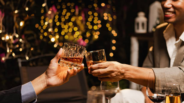 istock Happy two man clinking glasses of whiskey in celebration. 2190507802
