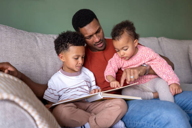istock Dad Reading a Storybook to the Children 2190508265
