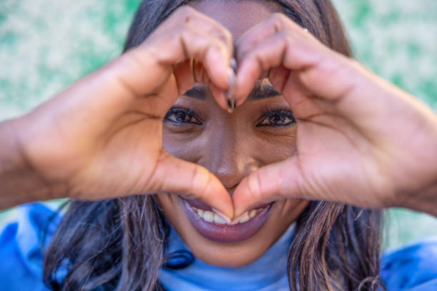 istock Young woman making heart shape with hands 2190508477