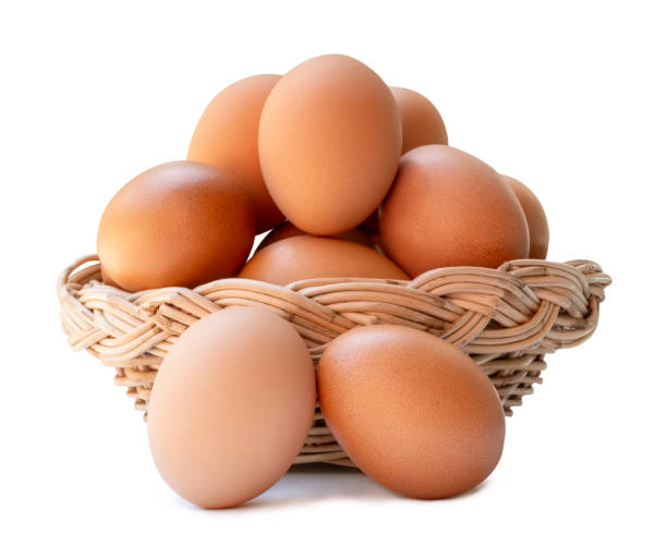 istock Group of fresh brown chicken eggs in stack in wicker basket isolated on white background with clipping path 2190508684