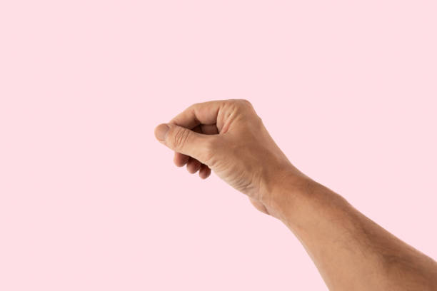 istock Male hand holding gesture isolated on pink background 2190509635
