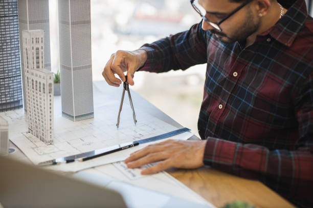 istock Indian architect measuring city plan for modern building design 2190510163