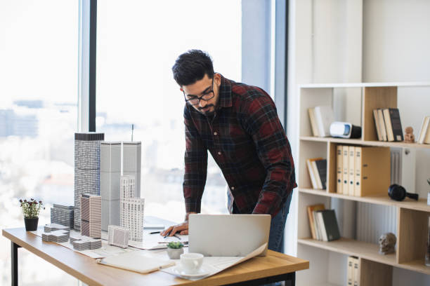 istock Indian male architect designing modern city project in office 2190510245