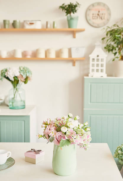 istock White kitchen interior. Shelves with dishes and kitchen utensils. Spring flowers in vase 2190510803