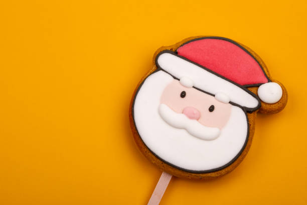 istock Santa Claus gingerbread cookie pop on yellow background 2190511640