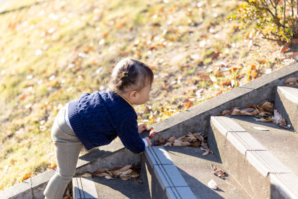 istock Little boy climbing up steps in public park 2190511727