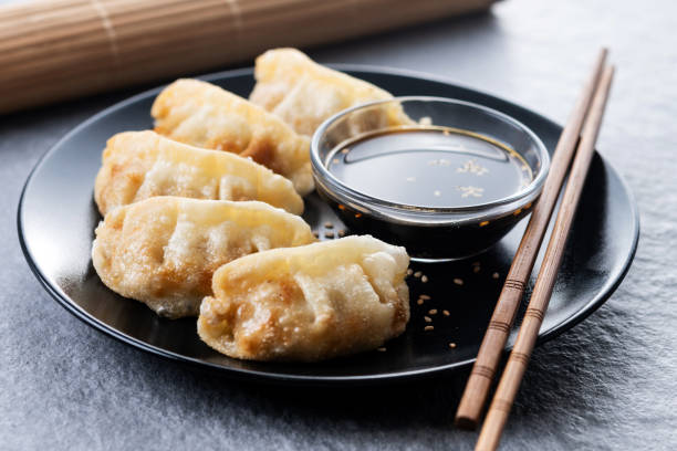 istock Fried dumplings gyoza on grey stone background 2190512735