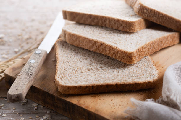 istock Healthy wholemeal bread slices on wooden table 2190513214