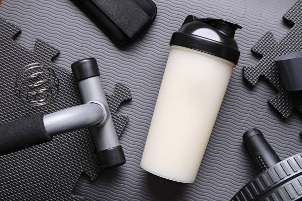 istock Protein drink and equipments on a grey mat background. 2190513823