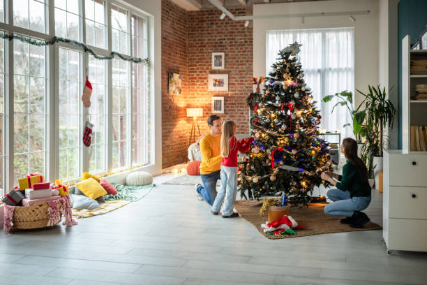 istock Family decorating a Christmas tree in a cozy living room setting 2190513903
