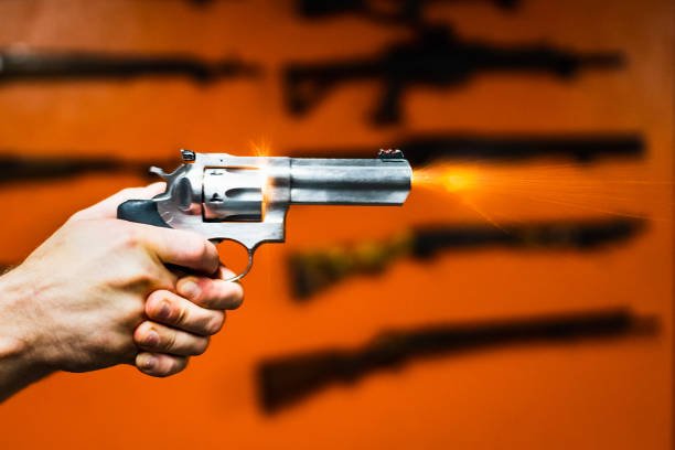 istock Shooting a revolver at a shooting range, sparks and flames fly from the barrel. 2190513957