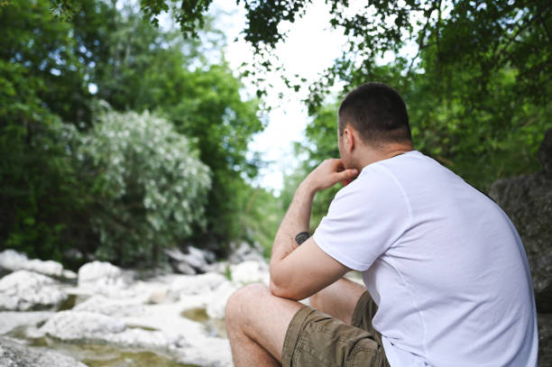 Thoughtful mid adult man at park