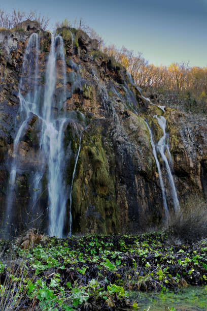 The Big Waterfall at Plitvice Lakes National Park cascades over a rocky cliff into lush greenery, showcasing nature's beauty and tranquility in Croatia's stunning landscape.