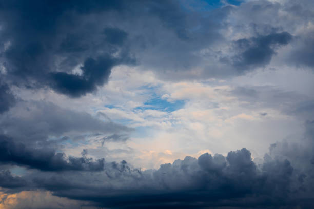Dramatic pre-storm sky with orange hues blending into dark blue clouds. Atmospheric scene before a storm. Copy space