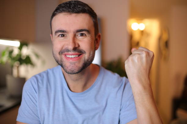 istock Excited man celebrating with hand gesture 2190521820