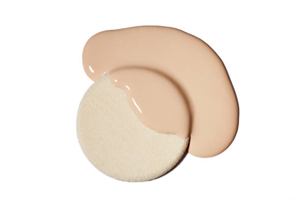 istock Makeup sponge with liquid foundation on white background. Beige concealer smear smudge isolated on white 2190522423