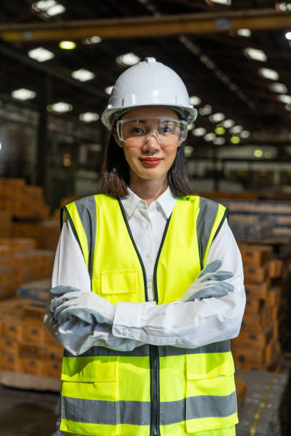 istock Professional female engineer and technician wearing safety helmet analyzing meeting with tablet in factory warehouse. Confident factory workers group inspection industry factory . Teamwork concept. 2190524114