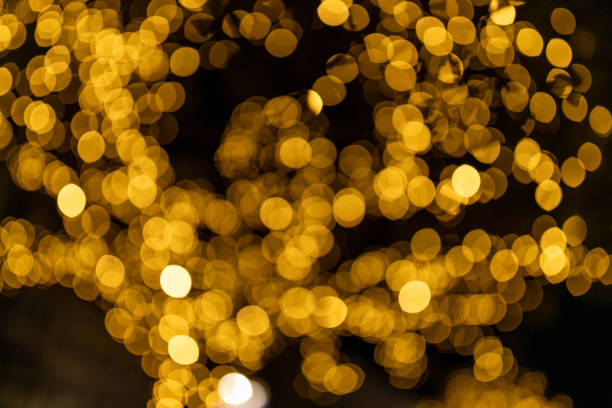 istock Decorative lights at night time, Defocused Background, night city backdrop, party time with Yellow bokeh balls. Abstract blurred warm light 2190527440