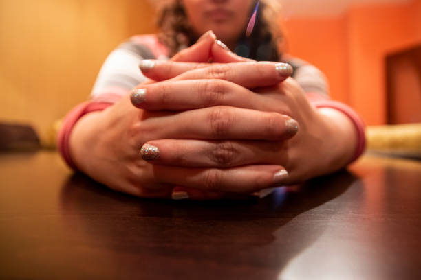 Closeup image of beautiful woman's hands with light pink manicure on the nails. Skin care for hands, manicure and beauty treatment. Elegant and graceful hands with slender graceful fingers