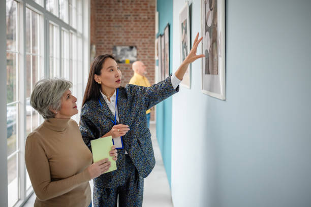 istock Art curator guiding visitors in a modern gallery setting 2190533036