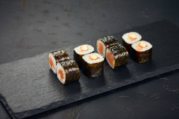 istock Roll with salmon on dark background. Sushi menu. Japanese food. 2190533147